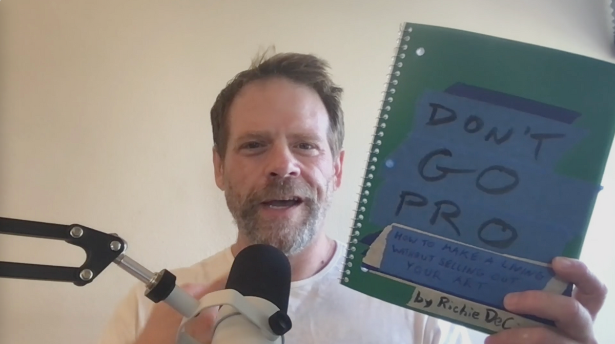 Load video: Richie DeCicco introduces his book Don't Go Pro, holding the notebooks he wrote it in